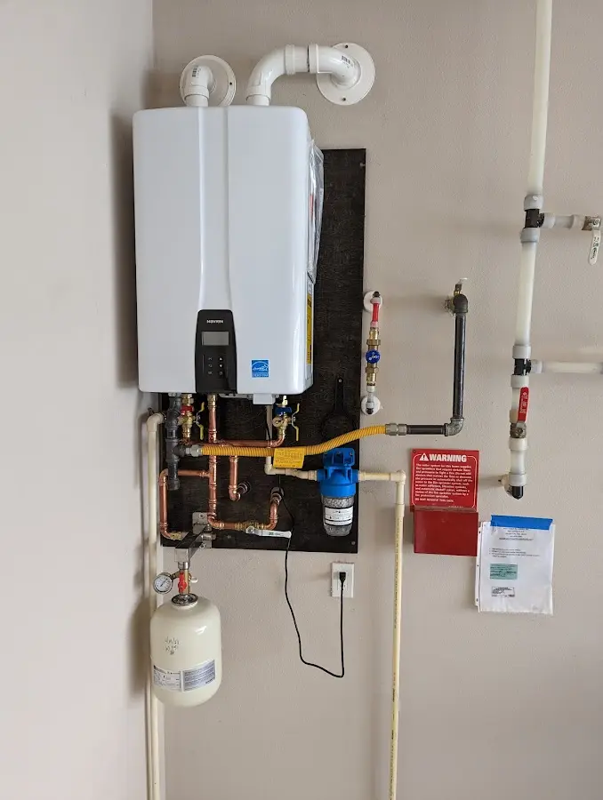 Professional plumber installing copper piping in a Garnett home